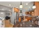 Open concept kitchen with stainless appliances, wood floors and bar seating at 3785 E 134Th Ct, Thornton, CO 80241