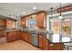 Kitchen featuring wood cabinets, granite countertops, and stainless steel appliances at 3785 E 134Th Ct, Thornton, CO 80241