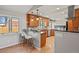 Bright kitchen with breakfast bar, pendant lighting, stainless appliances, and wood floors at 3785 E 134Th Ct, Thornton, CO 80241