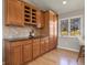 Traditional kitchen with natural wood cabinets, wine rack, granite countertops, and stainless appliances at 3785 E 134Th Ct, Thornton, CO 80241