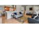 Stylish living room with hardwood floors, a cozy sofa, and an open staircase leading to the upper level at 3785 E 134Th Ct, Thornton, CO 80241