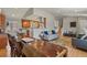 Spacious living area with an open-concept design, hardwood floors, and a stylish kitchen in the background at 3785 E 134Th Ct, Thornton, CO 80241