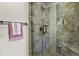 Tiled shower with glass door, rain shower head, and bench seating at 3785 E 134Th Ct, Thornton, CO 80241