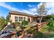 Backyard featuring a manicured lawn, fenced yard, landscaped garden, stone water feature, patio, and a covered deck at 5662 W Peakview Pl, Littleton, CO 80123
