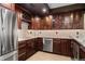 Stylish bar area featuring wood cabinets, a wine rack, granite countertops, tile backsplash, and stainless steel appliances at 5662 W Peakview Pl, Littleton, CO 80123