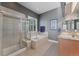 Bathroom with a shower, bathtub, tile floor, and double sink vanity at 5662 W Peakview Pl, Littleton, CO 80123