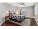 Well-lit bedroom with a wrought iron bed frame, hardwood floors, modern lamps, and a ceiling fan at 5662 W Peakview Pl, Littleton, CO 80123