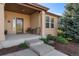 Inviting front porch featuring a seating area and a decorative glass front door at 5662 W Peakview Pl, Littleton, CO 80123