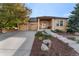 Charming single-story home featuring a well-manicured front yard and attached two-car garage at 5662 W Peakview Pl, Littleton, CO 80123