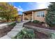 Beautiful home showcasing a meticulously landscaped front yard with rock accents and a cozy front porch at 5662 W Peakview Pl, Littleton, CO 80123