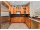 Well-equipped kitchen featuring stainless steel appliances, granite counters, and wood cabinetry at 5662 W Peakview Pl, Littleton, CO 80123