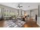 Inviting living room with a plush sectional, ceiling fan, and many windows providing great natural light at 5662 W Peakview Pl, Littleton, CO 80123