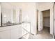 Modern bathroom with dual sinks, gray countertop, white cabinets, and tiled shower at 1989 S Haleyville Way, Aurora, CO 80018