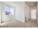 Bright bedroom features neutral carpet, large window with neighborhood views, and ensuite bathroom entrance at 1989 S Haleyville Way, Aurora, CO 80018