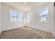 Bright bedroom featuring three large windows, neutral carpet, and ample sunlight at 1989 S Haleyville Way, Aurora, CO 80018