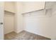 Walk-in closet features carpeted floors, shelving, and ample storage space at 1989 S Haleyville Way, Aurora, CO 80018