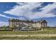 Exterior shot of a resort showcasing its architecture, landscaping, and amenities under a cloudy sky at 1989 S Haleyville Way, Aurora, CO 80018