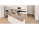 Modern kitchen with stainless steel appliances, gray countertop island, and white cabinets at 1989 S Haleyville Way, Aurora, CO 80018