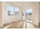 Bright room with wood floors, large window, and sliding glass door to the balcony at 1989 S Haleyville Way, Aurora, CO 80018