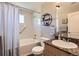 Traditional bathroom featuring granite counters, decorative shelving, and shower with tub at 8611 Gold Peak Dr # D, Highlands Ranch, CO 80130