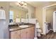 Well-lit bathroom featuring granite countertops, a large mirror, and a washer-dryer at 8611 Gold Peak Dr # D, Highlands Ranch, CO 80130