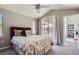Comfortable bedroom with ceiling fan, and sliding glass doors leading to the backyard patio at 8611 Gold Peak Dr # D, Highlands Ranch, CO 80130