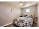 Cozy bedroom with a soft, upholstered headboard, reading lamps and a blue floral comforter at 8611 Gold Peak Dr # D, Highlands Ranch, CO 80130