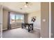 Bright bedroom with a ceiling fan, large window with a view, and modern desk setup at 8611 Gold Peak Dr # D, Highlands Ranch, CO 80130