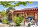 Community outdoor dining area with stone accents and ample seating under a pergola at 8611 Gold Peak Dr # D, Highlands Ranch, CO 80130