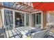 Sun-drenched patio featuring sliding glass doors, lounge chairs, and a shaded dining area at 8611 Gold Peak Dr # D, Highlands Ranch, CO 80130