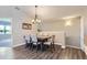 Elegant dining area featuring modern lighting, wood floors, and seating for six at 8611 Gold Peak Dr # D, Highlands Ranch, CO 80130