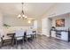 Elegant dining area featuring modern lighting, wood floors, and a stylish cabinet at 8611 Gold Peak Dr # D, Highlands Ranch, CO 80130