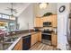 Well-appointed kitchen with wood cabinets, granite countertops, and stainless steel appliances at 8611 Gold Peak Dr # D, Highlands Ranch, CO 80130