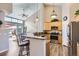 Modern kitchen featuring stainless steel appliances, a breakfast bar, and natural wood cabinets at 8611 Gold Peak Dr # D, Highlands Ranch, CO 80130