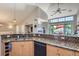 Functional kitchen with granite countertops, stainless steel appliances, and an open view to the living area at 8611 Gold Peak Dr # D, Highlands Ranch, CO 80130