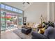 Bright living room with vaulted ceilings, comfortable seating, and access to a private patio at 8611 Gold Peak Dr # D, Highlands Ranch, CO 80130