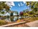 Picturesque pond surrounded by trees and foliage, offering a peaceful and scenic view at 8611 Gold Peak Dr # D, Highlands Ranch, CO 80130