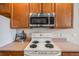 Well-equipped kitchen features an electric range and stainless steel microwave at 1430 Whitehall Dr # 9A, Longmont, CO 80504