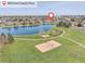 Aerial view of the park with a lake, playground, and volleyball court at 18292 E Caspian Pl, Aurora, CO 80013