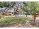 Backyard view showcasing a pergola, stone patio, lush lawn and mature trees at 18292 E Caspian Pl, Aurora, CO 80013