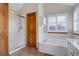 Bathroom showcasing tub, shower, shuttered window, and brown floor tiles at 18292 E Caspian Pl, Aurora, CO 80013