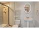 Bathroom featuring a shower and pedestal sink and oval mirror at 18292 E Caspian Pl, Aurora, CO 80013