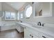 Bright bathroom features dual sinks, bathtub, and unique octagon-shaped window at 18292 E Caspian Pl, Aurora, CO 80013