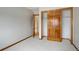 Cozy bedroom features neutral carpet, wood trim, and closet with wood doors at 18292 E Caspian Pl, Aurora, CO 80013
