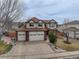 Charming two-story home with a three-car garage and well-manicured front yard at 18292 E Caspian Pl, Aurora, CO 80013