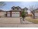Well-manicured two-story home with a three-car garage and inviting curb appeal at 18292 E Caspian Pl, Aurora, CO 80013