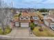 Well-maintained two-story home featuring a three-car garage, brick accents, and mature trees at 18292 E Caspian Pl, Aurora, CO 80013