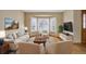 Bright living room with large bay window, hardwood floors, and comfortable seating arrangement at 18292 E Caspian Pl, Aurora, CO 80013