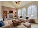 Cozy living room showcasing a brick fireplace, built-in shelves, and large windows at 18292 E Caspian Pl, Aurora, CO 80013