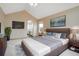 Spacious main bedroom with vaulted ceiling, ensuite bathroom access, and stylish decor at 18292 E Caspian Pl, Aurora, CO 80013